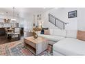 Cozy living room with modern furnishings, open floor plan, and staircase with black railing at 3036 Wilson Ct # 5, Denver, CO 80205