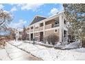 Two-story building exterior with snow-covered landscaping at 8200 E 8Th Ave # 2102, Denver, CO 80230