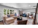 Spacious living room with large windows, comfortable seating, and stylish decor at 5020 W Quarles Dr, Littleton, CO 80128