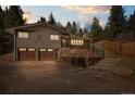 Charming home with a two-car garage, complemented by a retaining wall and manicured landscaping at 993 Fall River Rd, Idaho Springs, CO 80452