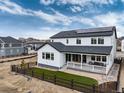 Stunning back exterior featuring a covered patio, solar panels, and well-manicured backyard at 3898 Descent St, Castle Rock, CO 80108