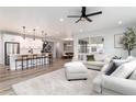 Expansive open concept living and dining area, featuring hard wood floors and ample natural light at 3898 Descent St, Castle Rock, CO 80108