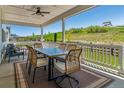 Inviting covered patio with outdoor dining set and scenic views of the green landscape and play area at 3898 Descent St, Castle Rock, CO 80108