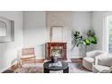 Stylish living room with a fireplace, hardwood floors, and neutral decor at 424 N Clarkson St, Denver, CO 80218