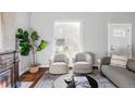 Bright living room with hardwood floors, fireplace, and natural light from the large window at 424 N Clarkson St, Denver, CO 80218