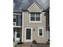 Charming townhome featuring neutral siding, decorative windows, and a welcoming front entrance with classic details at 10810 Summerset Way, Parker, CO 80138