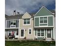 Three townhouses of different colors with landscaped lawns in a suburban neighborhood at 10810 Summerset Way, Parker, CO 80138