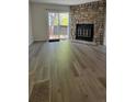 Open-concept living room with sliding glass doors and modern laminate flooring at 10810 Summerset Way, Parker, CO 80138
