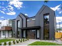 Modern duplex with dark siding, large windows, and professional landscaping at 2478 S Cherokee St, Denver, CO 80223