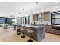Modern kitchen featuring a large island with seating, stainless steel appliances, and contemporary finishes at 2478 S Cherokee St, Denver, CO 80223