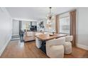 Open-concept living room with hardwood floors, modern lighting, and comfortable seating throughout at 796 Ivanhoe St, Denver, CO 80220