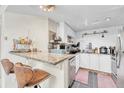 Modern kitchen with granite countertops, stainless steel appliances and bar stool seating at 8701 Huron St # 211, Thornton, CO 80260