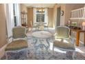 Cozy living room with two armchairs and a round table at 4236 Lark Sparrow St, Highlands Ranch, CO 80126