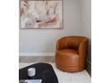 Living room boasting a brown leather chair, black table, and modern decor at 1020 Stuart, Denver, CO 80204