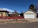 Detached two-car garage with a red fence and a clear blue sky backdrop at 1992 S Lincoln St, Denver, CO 80210