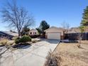 Lovely home with a spacious driveway and well-kept yard, perfect for suburban living at 13640 W Center Dr, Lakewood, CO 80228