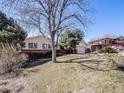 Well-maintained single-story home with mature trees and landscaping, offering great curb appeal at 13640 W Center Dr, Lakewood, CO 80228