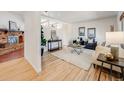 Bright and airy living room with hardwood floors, a cozy fireplace, and stylish decor at 13640 W Center Dr, Lakewood, CO 80228