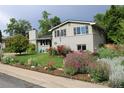 Beautiful two-story home showcasing lush landscaping and a well-maintained lawn at 6864 Balsam St, Arvada, CO 80004