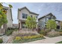 Beautifully landscaped two-story home featuring a welcoming front porch and classic architectural details at 11270 E 26Th Ave, Aurora, CO 80010