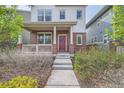 Inviting front exterior with a cozy porch, brick detailing, and a charming wreath on the front door at 11270 E 26Th Ave, Aurora, CO 80010