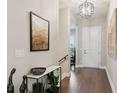 Inviting entryway featuring hardwood floors, modern light fixture and stylish decor at 22065 E Bailey Pl, Aurora, CO 80016
