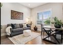 Cozy living room featuring a comfortable sofa, natural light, and stylish decor at 22065 E Bailey Pl, Aurora, CO 80016