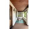Inviting front porch with rocking chairs, stylish rug and a wood-paneled ceiling at 1220 S Vine St, Denver, CO 80210