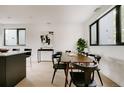 Elegant dining area with modern art and large windows, perfect for entertaining and Gathering meals at 1601 Park Ave # 214, Denver, CO 80218