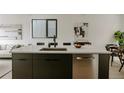 Modern kitchen with sleek cabinets, stainless steel appliances, and a spacious island with bar seating at 1601 Park Ave # 214, Denver, CO 80218