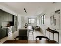 Contemporary kitchen with island seating, modern appliances, and open floor plan leading into the living area at 1601 Park Ave # 214, Denver, CO 80218