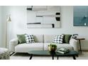 Cozy living room featuring a comfortable sofa, stylish decor, and natural light from the window at 1601 Park Ave # 214, Denver, CO 80218