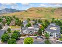 Scenic aerial view showing lush landscaping, mature trees, and mountain views surrounding this lovely community at 1670 S Deframe St # B2, Lakewood, CO 80228