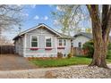 Charming single-story home with a well-manicured lawn and inviting curb appeal from a street view at 2472 Ames St, Edgewater, CO 80214