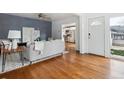Open-concept living room featuring hardwood floors, neutral decor, and a seamless transition to the adjacent kitchen at 2472 Ames St, Edgewater, CO 80214