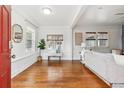 Bright living room with hardwood floors, white walls and trim, and large windows, providing ample natural light at 2472 Ames St, Edgewater, CO 80214