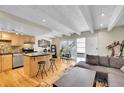 Inviting living room showcasing an island, stainless steel appliances, and hardwood floors at 33 Corona St # 207, Denver, CO 80218