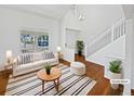 Bright living room with white walls, hardwood floors, and a large window providing natural light at 9515 Bexley Dr, Highlands Ranch, CO 80126