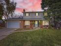 Brick home with a two-car garage and front yard lighting at 824 S Nelson Way, Lakewood, CO 80226