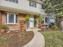 Welcoming front entrance with brick facade and hanging plants at 824 S Nelson Way, Lakewood, CO 80226