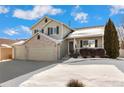 Two-story house with a three-car garage and partially snow-covered landscaping at 10890 W Belmont Ave, Littleton, CO 80127