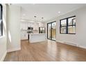 Open-concept kitchen with white cabinets, island, and stainless steel appliances at 1563 N Hooker St, Denver, CO 80204