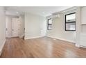 Bright living room with hardwood floors and modern black-trim windows at 1563 N Hooker St, Denver, CO 80204