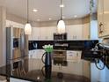 Modern kitchen with stainless steel appliances and granite countertops at 15602 E Dorado Pl, Centennial, CO 80015