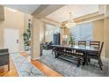 Elegant dining room featuring a chandelier, hardwood floors, and ample seating at 2835 S Jebel Way, Aurora, CO 80013