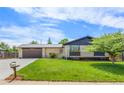 Well-maintained exterior with lush green lawn, attached garage, and lovely curb appeal under a bright sky at 13010 W 6Th Pl, Golden, CO 80401
