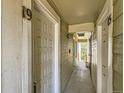 Hallway featuring doors with numbers 19 and 16 with olive green wood paneling and view of the outdoors at 962 S Dearborn Way # 19, Aurora, CO 80012