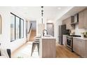 Bright kitchen features modern appliances, ample counter space, and a breakfast bar at 3433 Lawrence St # 1, Denver, CO 80205