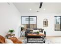 Stylish living room features modern furniture, decor and natural lighting at 3433 Lawrence St # 1, Denver, CO 80205