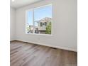 Sun-filled bedroom with expansive windows and warm-toned hardwood floors at 8241 Rockvale Dr, Littleton, CO 80125